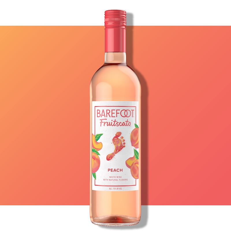 Barefoot Fruitscato Peach bottle against a peach and coral gradient background with peach imagery on the label