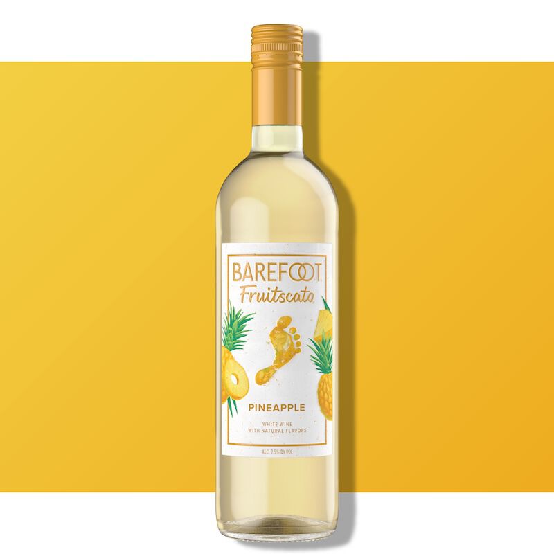 Barefoot Fruitscato Pineapple bottle against a bright yellow background with pineapple imagery on the label